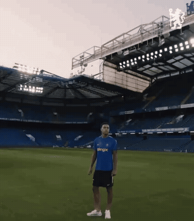 Man In Blue Shirt Saying Pingx In Front Of Soccer Stadium GIF