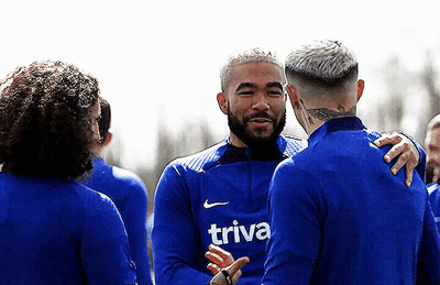 Man In Blue Shirt Saying Trivia Talks To Another Man GIF