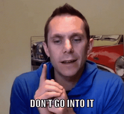 Man In Blue Shirt Says Don't Go Into It In Front Of Red Car GIF