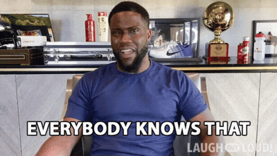 Man In Blue Shirt Says Everybody Knows That In Front Of Trophies GIF