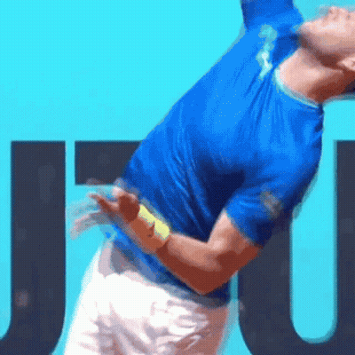 Man In Blue Shirt Serving Tennis Ball GIF