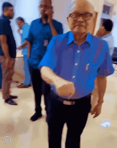 Man In Blue Shirt Shaking Hands GIF