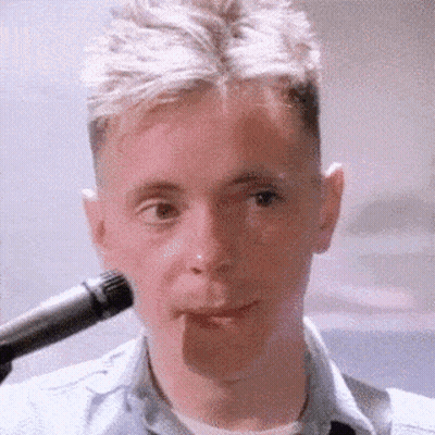 Man In Blue Shirt Singing Into Microphone GIF