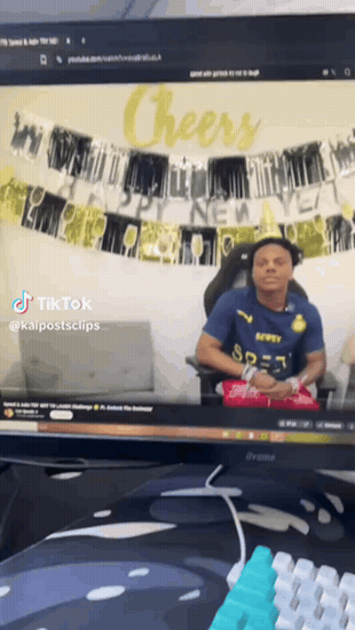 Man In Blue Shirt Sitting At Computer Saying Cheers GIF