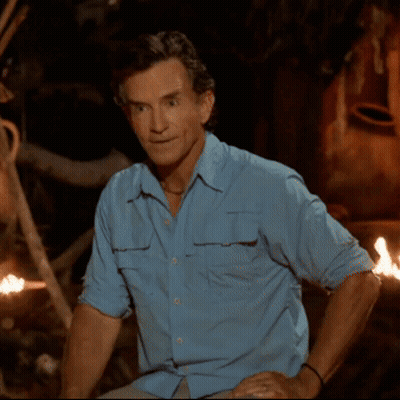 Man In Blue Shirt Sitting By Fire GIF