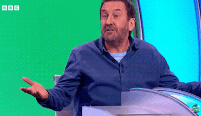 Man In Blue Shirt Sitting In Front Of Green Screen With BBC GIF