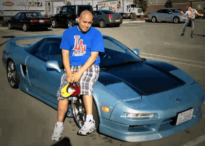 Man In Blue Shirt Sitting On Car Hood GIF