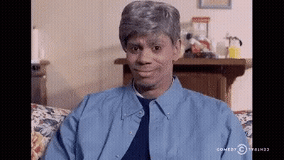 Man In Blue Shirt Sitting On Couch With Comedy Central Logo GIF