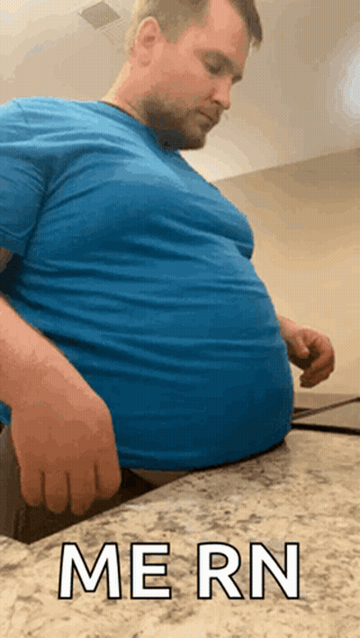 Man In Blue Shirt Sitting On Counter Saying Mern GIF