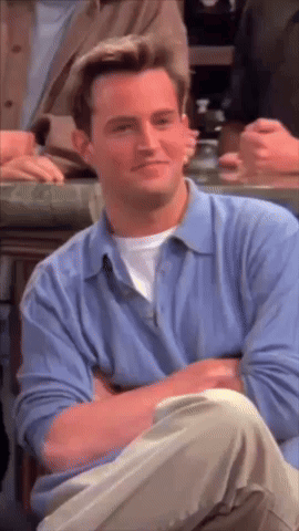 Man In Blue Shirt Sitting With Arms Crossed Smiling GIF