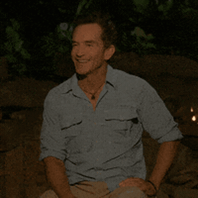 Man In Blue Shirt Sitting With Hands On Knees GIF