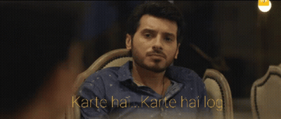 Man In Blue Shirt Sitting With Karte Hai Karte Hai Log GIF