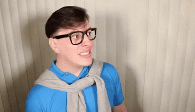 Man In Blue Shirt Smiling And Making A Face GIF
