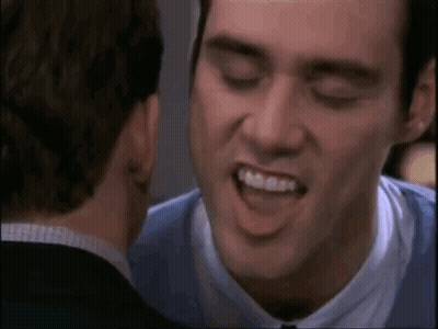 Man In Blue Shirt Smiling At Man In Suit GIF