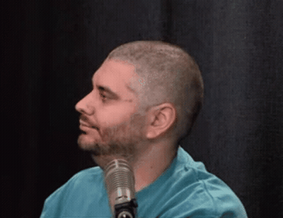 Man In Blue Shirt Smiling At Microphone GIF