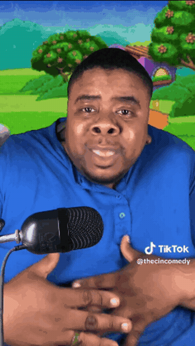 Man In Blue Shirt Smiling At Microphone GIF