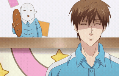 Man in Blue Shirt Smiling in Front of Cartoon Character