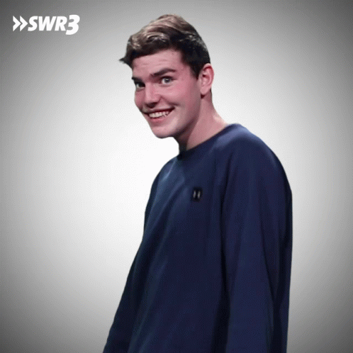 Man In Blue Shirt Smiling In Front Of SWR3 Sign GIF