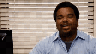 Man In Blue Shirt Smiling In Front Of Window With Blinds GIF