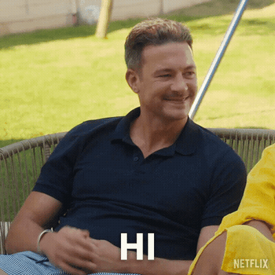 Man In Blue Shirt Smiling With Hi On Chest GIF