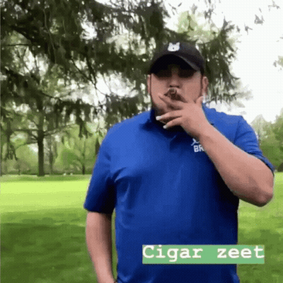 Man In Blue Shirt Smoking Cigar Saying Cigar Zeet GIF