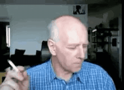 Man In Blue Shirt Smoking Cigarette GIF