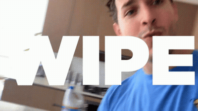 Man In Blue Shirt Standing At Wipe Sign GIF