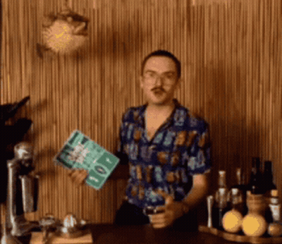 Man In Blue Shirt Standing By Wooden Wall GIF