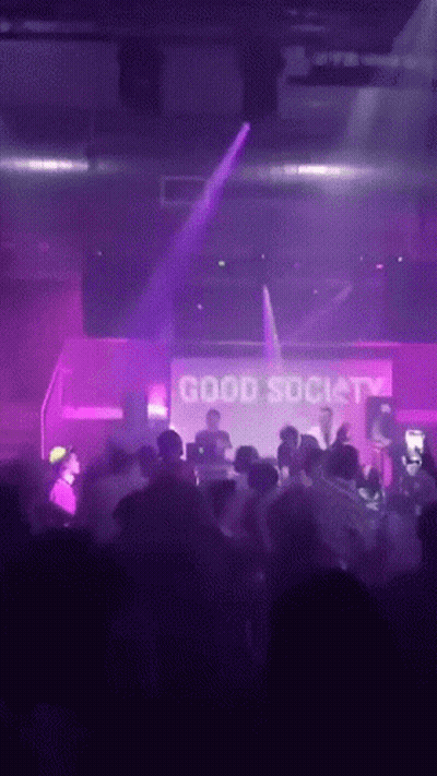 Man In Blue Shirt Standing In Crowd GIF