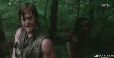 Man In Blue Shirt Standing In Forest GIF
