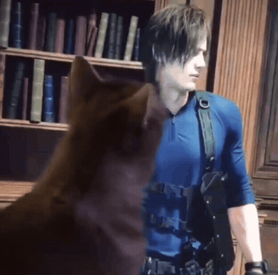 Man In Blue Shirt Standing Next To Brown Cat GIF