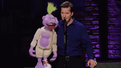 Man In Blue Shirt Standing Next To Puppet GIF
