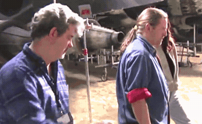 Man In Blue Shirt Standing Next To Woman GIF