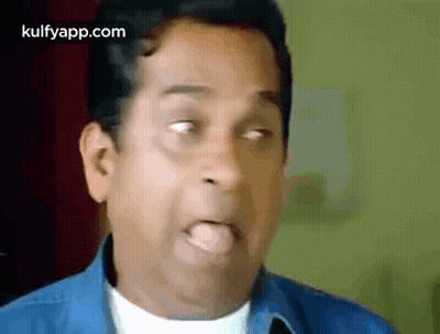 Man In Blue Shirt Sticking Tongue Out GIF