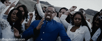 Man In Blue Shirt Surrounded By Dancing Crowd GIF