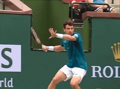 Man In Blue Shirt Swinging Tennis Racket GIF