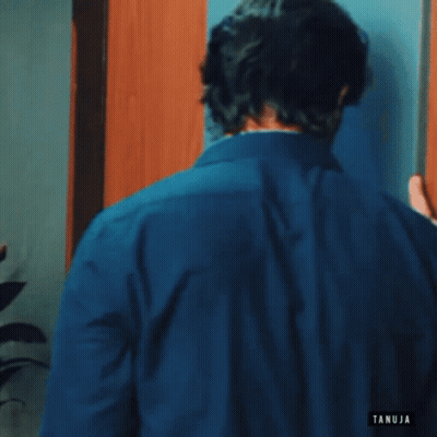 Man In Blue Shirt Talking On Cell Phone GIF