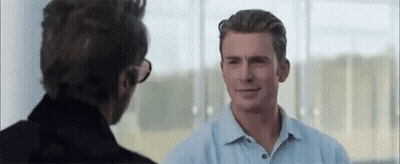 Man In Blue Shirt Talking To Man In Black Jacket GIF