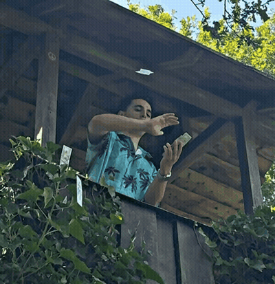 Man In Blue Shirt Throwing Money Including 100 Dollar Bill GIF