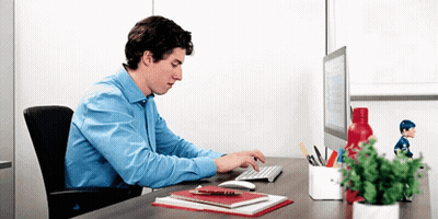 Man In Blue Shirt Typing At Desk GIF
