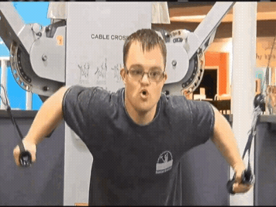 Man In Blue Shirt Using Cable Cross Machine GIF