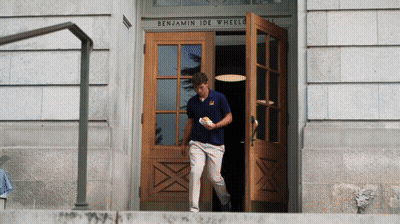 Man In Blue Shirt Walking Into Benjamin Ide Wheeler Building GIF