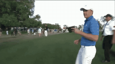 Man In Blue Shirt Walking On Golf Course GIF