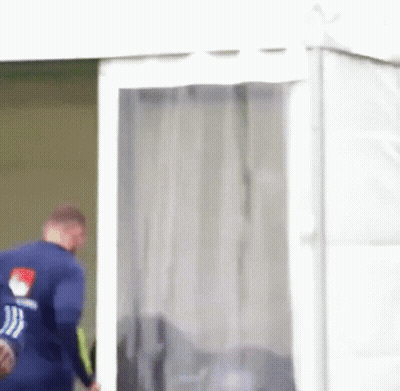 Man In Blue Shirt Walking Out Of Tent GIF