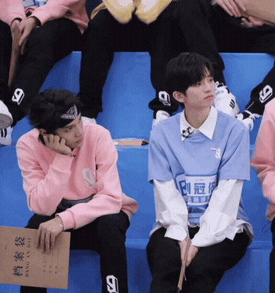 Man In Blue Shirt With 9 Next To Man In Pink Sweater GIF