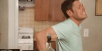 Man In Blue Shirt With Bottle Of Alcohol GIF
