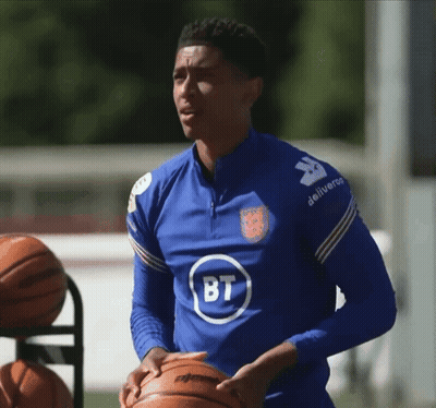 Man In Blue Shirt With BT Holding Basketball GIF