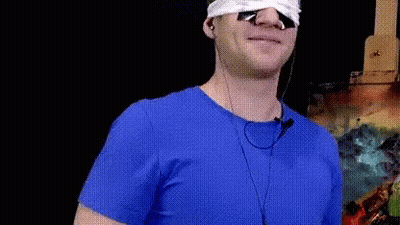 Man In Blue Shirt With Earbuds GIF