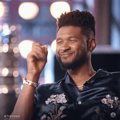 Man In Blue Shirt With Flowers Smiling And Laughing GIF