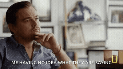 Man In Blue Shirt With Hand On Chin GIF